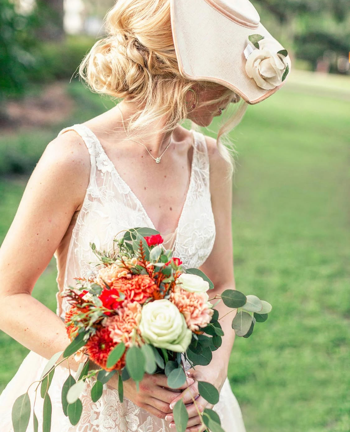 Bride holding bouquet in lace gown